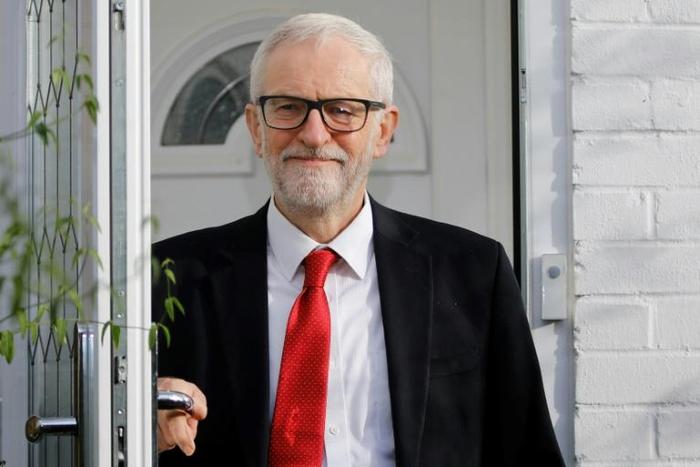 Corbyn defended his far-left campaign platform and gave no clear indication of when he might step down