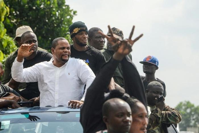Liberian radio show host and opposition leader Henry Costa (2nd L) is one of those behind the anti-government protests