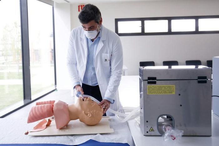 A member of Spanish car manufacturer SEAT's medical service checks a ventilator manufactured at its factory outside Barcelona after the firm switched production in the battle to tackle COVID-19