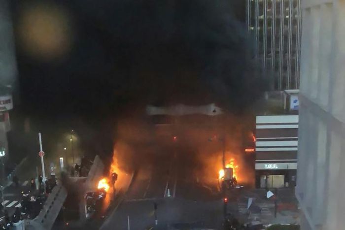 A picture shows vehicles and bins burning near the Gare de Lyon rail station in Paris on February 28, 2020; police said they tried to stop protesters who set alight garbage bins and scooters