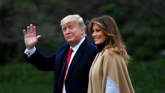 US President Donald Trump waves next to First Lady Melania Trump as they walk to Marine One before departing from the South Lawn of the White House
