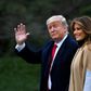 US President Donald Trump waves next to First Lady Melania Trump as they walk to Marine One before departing from the South Lawn of the White House