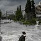 A man wearing a protective face mask walks at empty Athens' empty Syntagma square on March 23, 2020 as the country struggles to control the spread of the COVID-19, the novel coronavirus