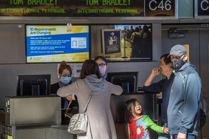Stand-by passengers trying to get out of China make flight enquiries at the airport