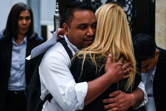 Hugo Pinto Exposto (C), the son of Maria Elvira Pinto Exposto (not pictured), reacts after a Malaysian court overturned her death sentence for drug trafficking and ordered her release