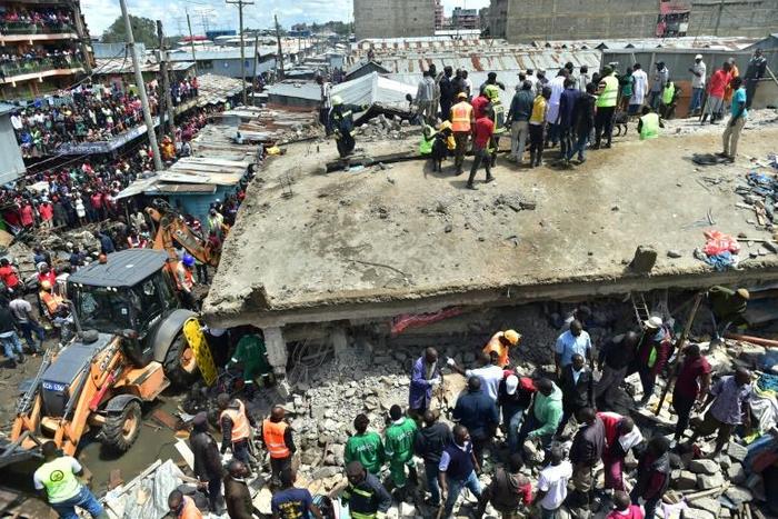 Onlookers swarmed the twisted ruins of the six-floor building, using their bare hands to pull out injured people