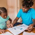 Edine Celestin (R) is homeschooling her five-year-old daughter Lyne-Renee as schools have been closed in Haiti's capital Port-au-Prince because of political unrest