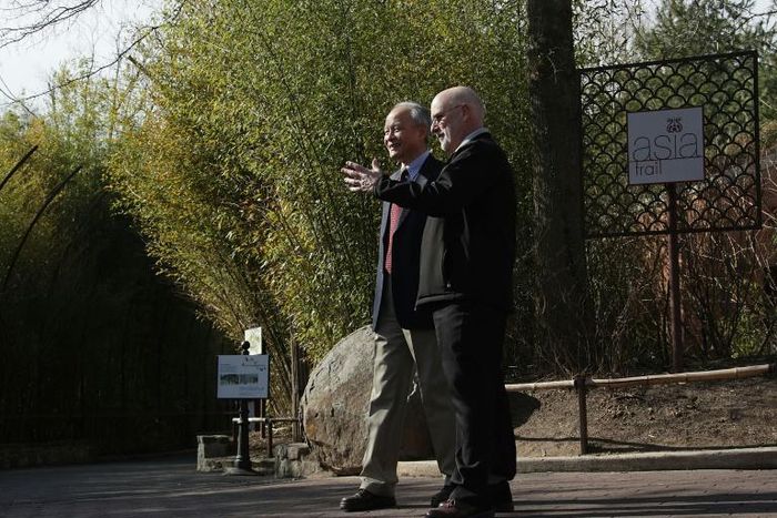 Chinese Ambassador Cui Tiankai (left) speaks to the director of the National Zoo, Dennis Kelly, as they wait for the departure of giant panda Bao Bao in February 2017