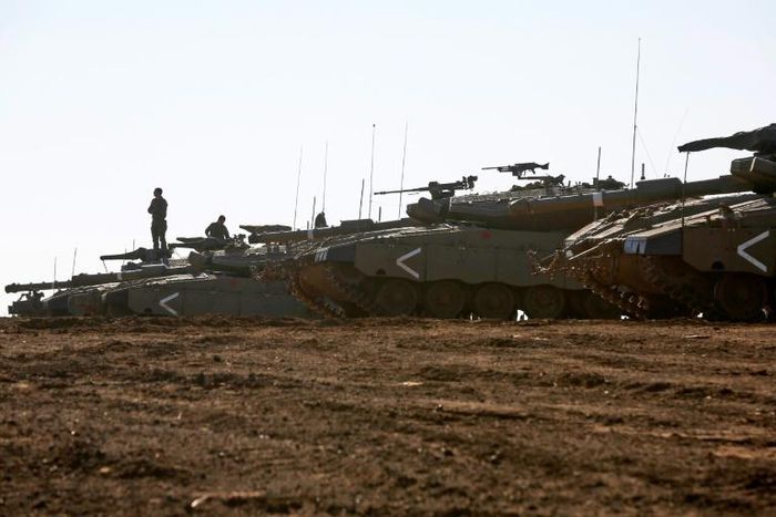 Israeli tanks stand guard close to the armistice line with Syria on the strategic Golan Heights