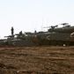Israeli tanks stand guard close to the armistice line with Syria on the strategic Golan Heights