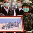 Taiwan President Tsai Ing-wen receives a framed photograph from a masked soldier during the COVID-19 coronavirus pandemic during a visit to a military base in Tainan on April 9, 2020