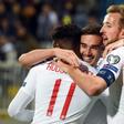 England's Harry Winks (C) celebrates after scoring the opening goal against Kosovo