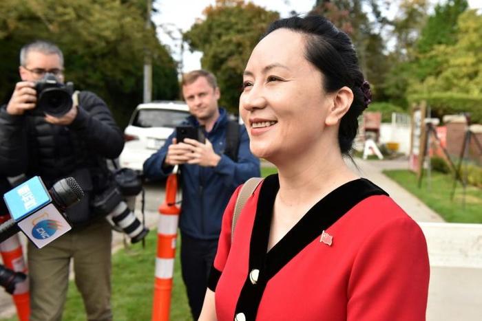 Huawei Chief Financial Officer, Meng Wanzhou, stops to talk to media while leaving her Vancouver home to appear in British Columbia Supreme Court, in Vancouver, on October 1, 2019