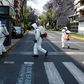 Cleaning workers wearing personal protective equipment disinfect a street in Mexico City amid the COVID-19 outbreak