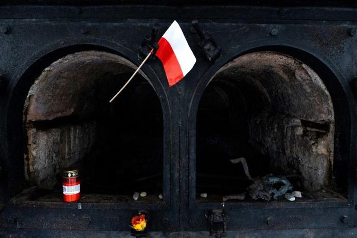 A Polish flag waves in front of a crematorium oven at the former site of the Gusen death camp in Austria, which Warsaw is pushing to be memorialised