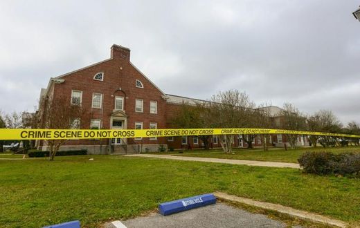 Police tape cordons off an area after a shooting at the Pensacola Naval Air Station in December 2019