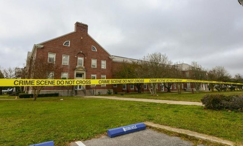 Police tape cordons off an area after a shooting at the Pensacola Naval Air Station in December 2019