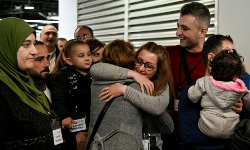 Host families and volunteers greeted the new arrivals -- some of them family members -- with smiles and tears