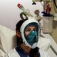 A medical worker tests a Decathlon snorkeling mask, with a 3D-printed respiratory valve fitting attached, at the Erasme Hospital in Brussels