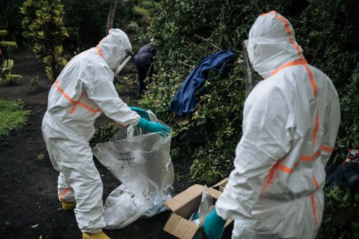 Two staff members of the Congolese Ministry of Health pack their equipment after performing a COVID-19 test at a private residence in Goma, northeastern Democratic Republic of Congo, on March 31, 2020