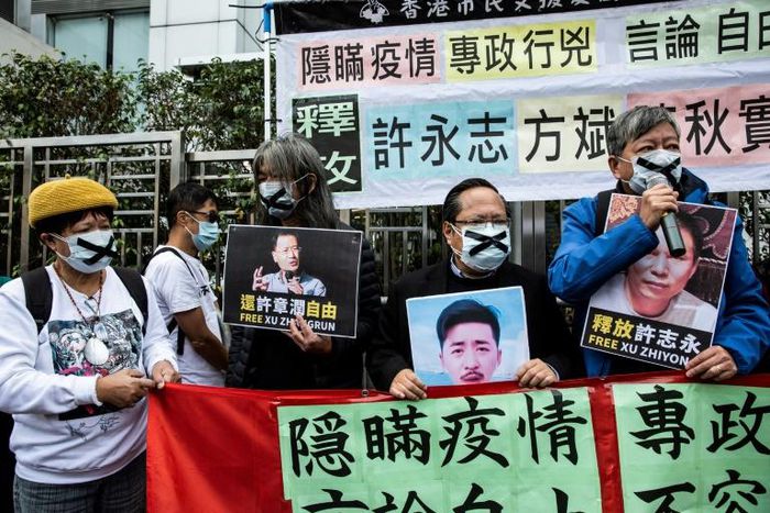 Pro-democracy protesters in Hong Kong hold placards supporting  detained rights activists including Xu Zhiyong in February 2020