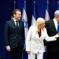 French President Emmanuel Macron (L) is welcomed by Israeli Prime Minister Benjamin Netanyahu (R) and his wife Sara (C) in Jerusalem on Wednesday