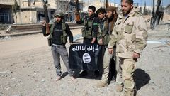 Turkish-backed Syrian fighters take down a black Islamic State group flag during their capture of the northern town of Al-Bab in February 2017