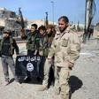 Turkish-backed Syrian fighters take down a black Islamic State group flag during their capture of the northern town of Al-Bab in February 2017