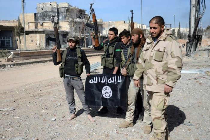 Turkish-backed Syrian fighters take down a black Islamic State group flag during their capture of the northern town of Al-Bab in February 2017