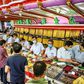 Customers in facemasks selling gold at a shop in Bangkok's Chinatown