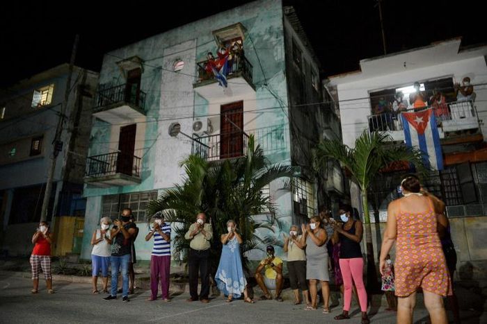 Neighbours applaud doctors and nurses who are battling the virus in Havana on March 30, 2020. Cuba is having trouble securing the medical supplies it needs to fight the pandemic