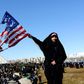 An Iranian woman marks the 41st anniversary of the Islamic republic by burning the US flag in Tehran's Azadi Square