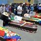 Relatives mourn by the coffins of protesters killed during protests in the Bolivian town of Sacaba on November 16, 2019