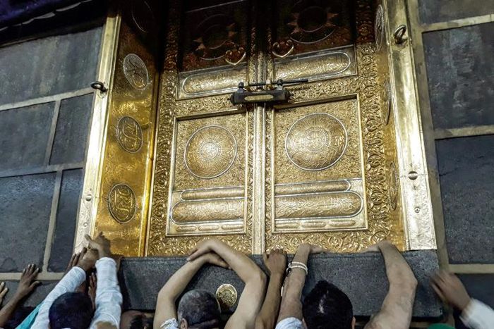 Muslims pilgrims gather outside the door of the Kaaba, Islam's holiest shrine, in Mecca, Saudi Arabia