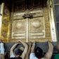 Muslims pilgrims gather outside the door of the Kaaba, Islam's holiest shrine, in Mecca, Saudi Arabia