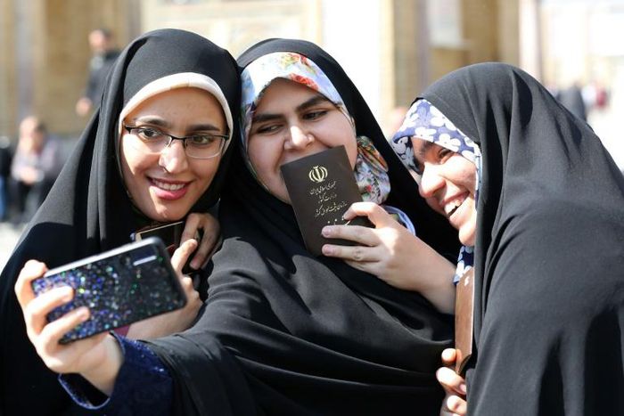 Iranian voters pose for a selfie during parliamentary elections at the Shah Abdul Azim shrine on the southern outskirts of Tehran on Friday