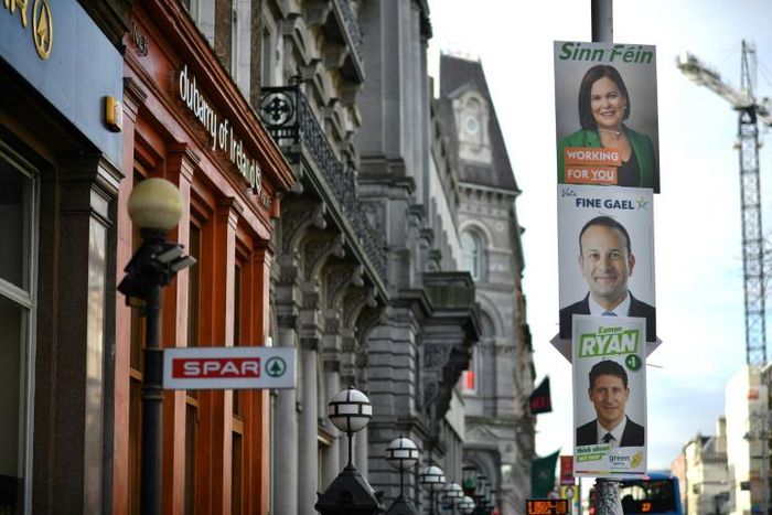 Election posters featuring Sinn Fein President Mary Lou McDonald (top), Irish Prime Minister Leo Varadkar (middle) seen in Dublin ahead of a general election on Sunday