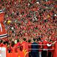 Fans of Guangzhou Evergrande cheer for the team after defeating Shanghai Shenhua to win the Chinese Super League (CSL) football championship in Guangzhou in China's southern Guangdong province in December