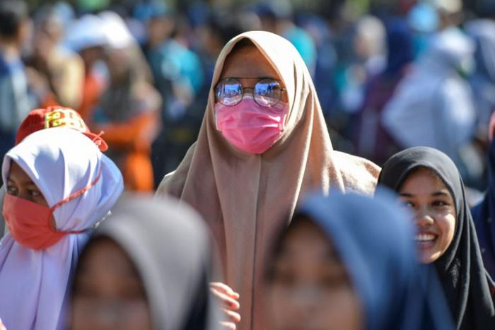 A woman wears a face mask in Banda Aceh, Indonesia on March 14, 2020