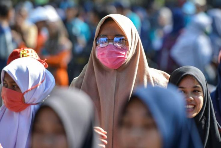 A woman wears a face mask in Banda Aceh, Indonesia on March 14, 2020