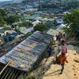 Rohingya refugees walk among makeshift houses in the Jamtoli Refugee Camp in Ukhia, Bangladesh in December 2019