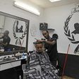 Israeli Ethiopian Jewish hairdresser Baruch works at his barbershop in the southern Israeli city of Ashkelon. Israel's 140,000-strong Ethiopian-Israeli community could  prove pivotal in the Jewish state's tight March 2 election.