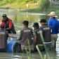 Australian crocodile wranglers  Matthew Nicolas Wright (right) and Chris Wilson (left) directing the lndonesian team in setting the trap in the river in Palu