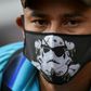 A Venezuelan migrant wears a face mask as he waits to board a bus to voluntarily return to his country because of the novel coronavirus in Cali, Colombia, on April 14