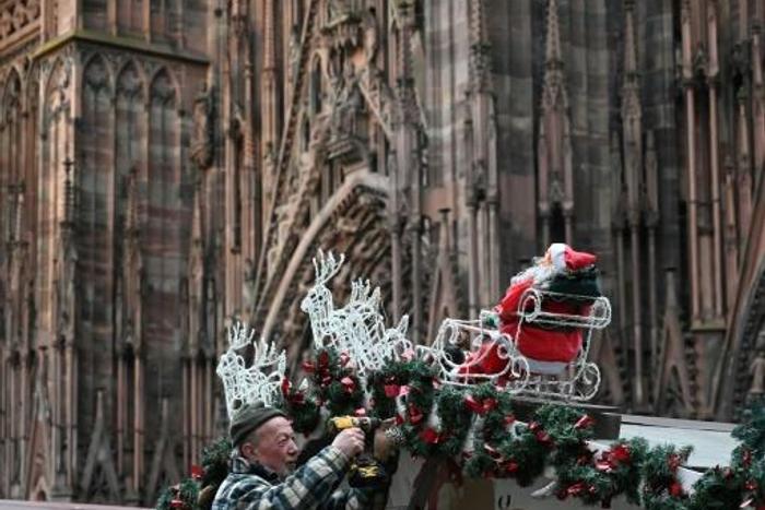 A worker installs decorations at the market, which will see a beefed up security presence this year
