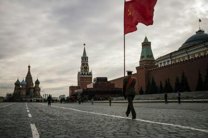 Russian Communist party activists and supporters march towards Lenin's Mausoleum for a ceremony on Red Square in Moscow
