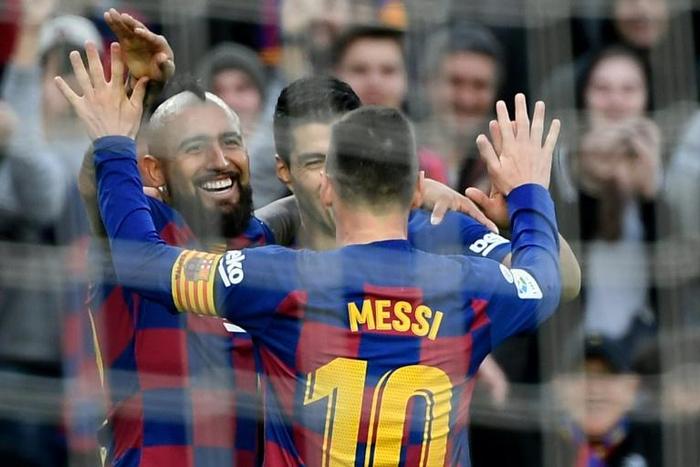 Arturo Vidal and Luis Suarez celebrate after Lionel Messi's goal