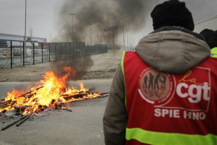 French strikers set fires and barricades to block access to the port at Le Havre on Wednesday to protest the pension overhaul.
