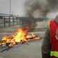 French strikers set fires and barricades to block access to the port at Le Havre on Wednesday to protest the pension overhaul.