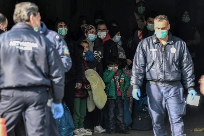 Migrants arrive at the port of Kavala on March 21, 2020, to be transferred to a closed camp in northern Greece as the country battles hard to control the novel coronavirus
